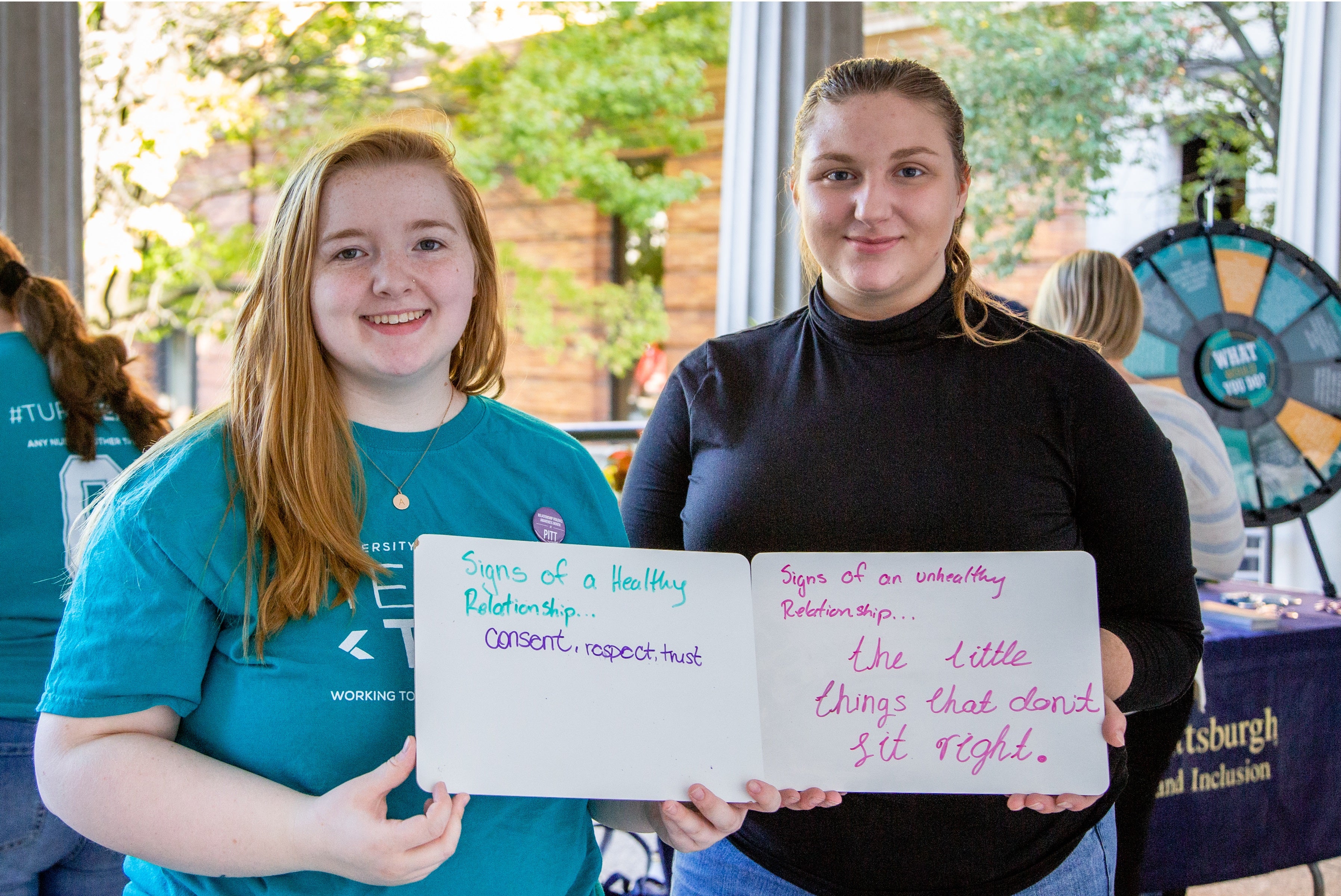 Students hold signs during the sexual violence resource fair