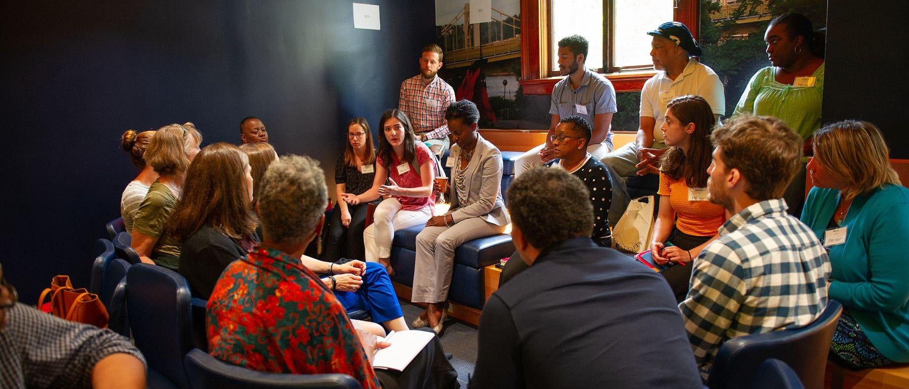 Group of students, faculty, and staff having a discussion
